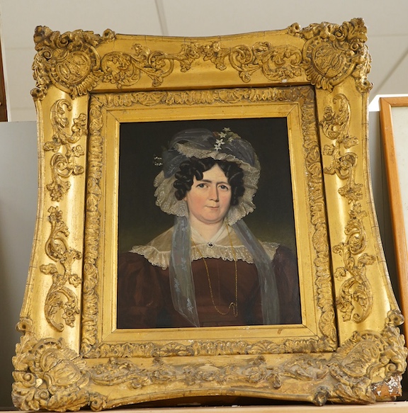 Regency School, circa 1800, Head and shoulders portrait of a lady wearing a bonnet, unsigned, oil on millboard, 24 x 19cm, ornate gilt frame